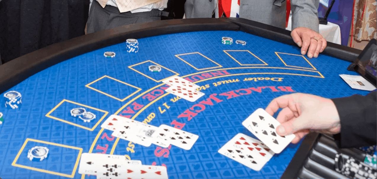 Croupier dealing cards on a professional blackjack table with chips on the betting spots