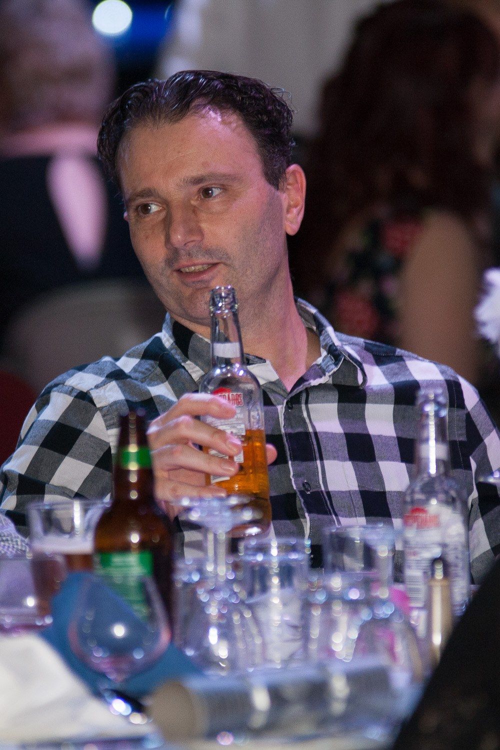 Guest holding a drink at an evening party