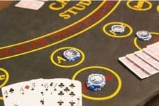 Stud poker table with cards and chips