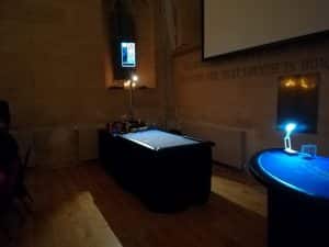 Casino tables set up in a dark venue before guests arrive