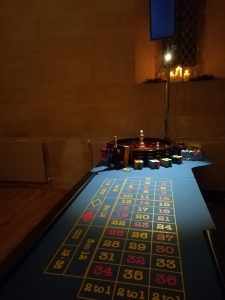 Roulette table with wheel lit up in a historic stone venue