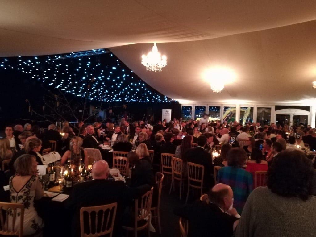 Large marquee dinner with guests seated at round tables