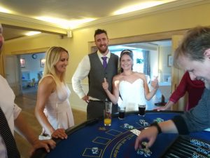 Bride and groom with guests at a blackjack table