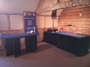 Two casino tables set up in a barn venue