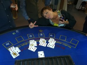 Guest posing for the camera at a blackjack table