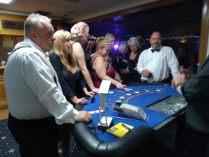 Guests playing blackjack at an evening party