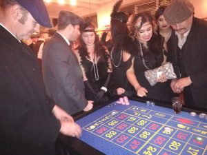 Guests in 1920s Peaky Blinders costume playing roulette