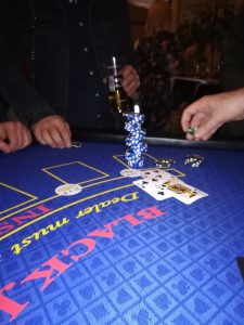 Blackjack hand being played with a stack of chips