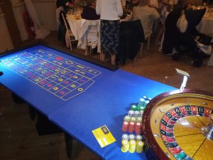 Roulette table and wheel set up at a dinner party