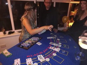 Guests playing blackjack at a party