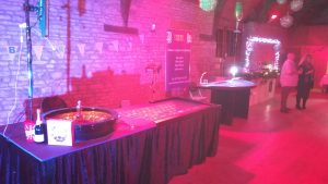 Roulette table under pink party lighting