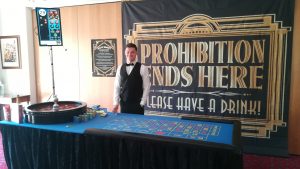 Roulette table in front of a Prohibition themed backdrop