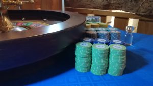 Stacks of roulette chips beside the wheel