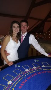 Bride and groom posing at a blackjack table