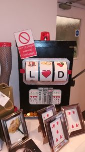 Slot machine and playing card decorations at a casino party