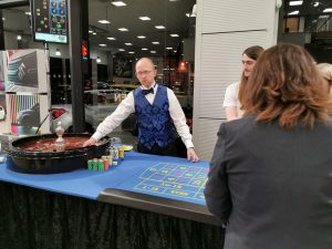 Croupier running roulette at a corporate event in a car showroom