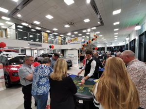 Guests playing casino games at a car showroom event
