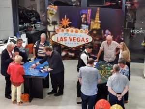 Casino tables in front of a Las Vegas backdrop at a showroom event