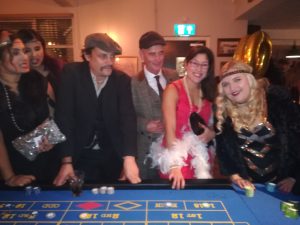 Guests in 1920s costume at a roulette table