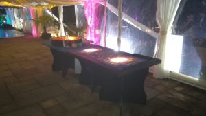 Casino tables set up inside a lit marquee