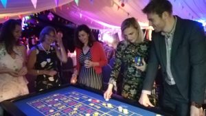 Guests playing roulette in a marquee at night