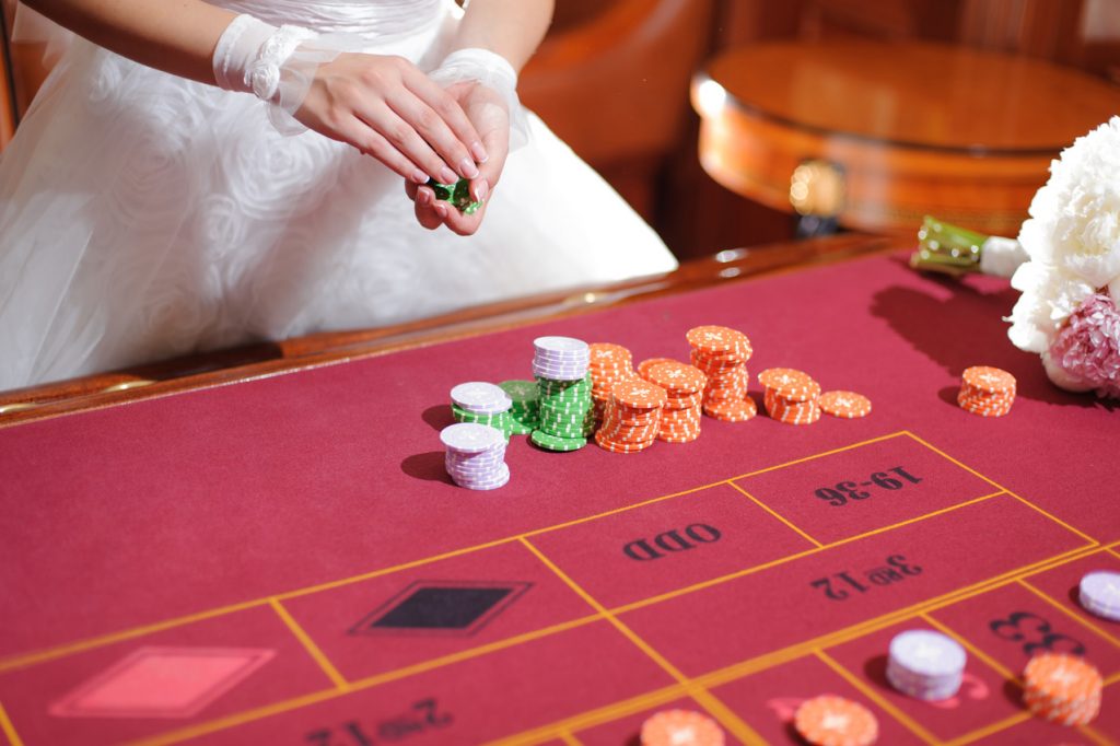 Bride placing chips on a roulette table