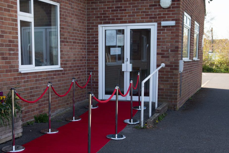 Red carpet and poles at a venue entrance