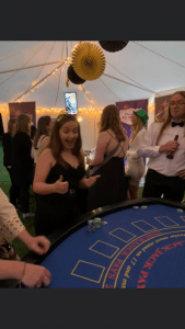 Guests at a blackjack table in a marquee