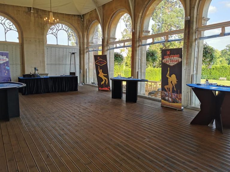 Casino tables and Las Vegas banners set up in an orangery