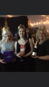 Three winners holding prizes at the end of the night