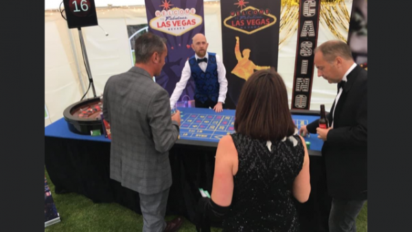 Guests at a roulette table in a Las Vegas themed marquee