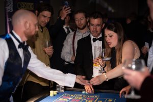 Croupier paying out a winning guest at a black tie event