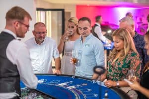 Guests playing blackjack at a summer ball