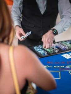 Croupier dealing blackjack with a chip tray