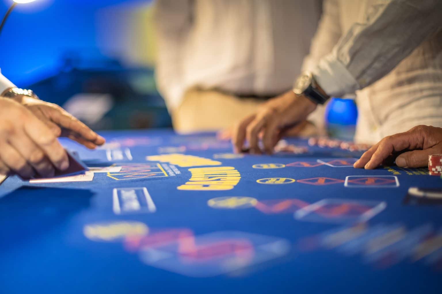 Players placing bets on a 3 Card Brag table