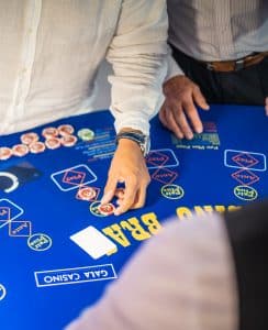 Player placing chips on a 3 Card Brag table