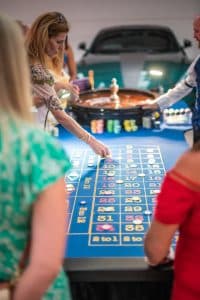 Guests playing roulette at a summer ball