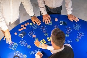 Players around a 3 Card Brag table from above