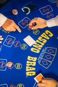 Close-up of a 3 Card Brag table with cards and chips