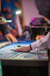 Croupier collecting chips at a roulette table