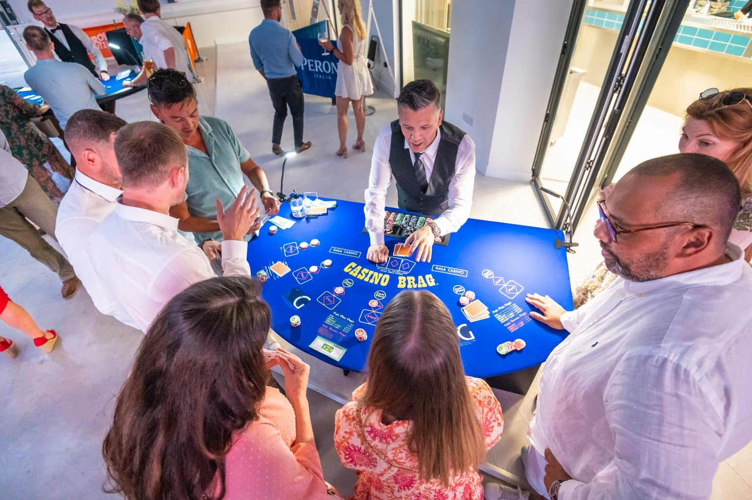 Players gathered around a 3 Card Brag table