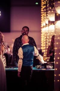 Croupier at a roulette table under fairy lights