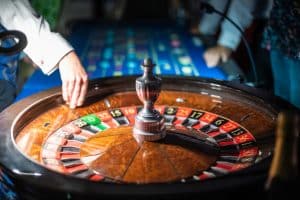 Croupier's hand on the roulette wheel