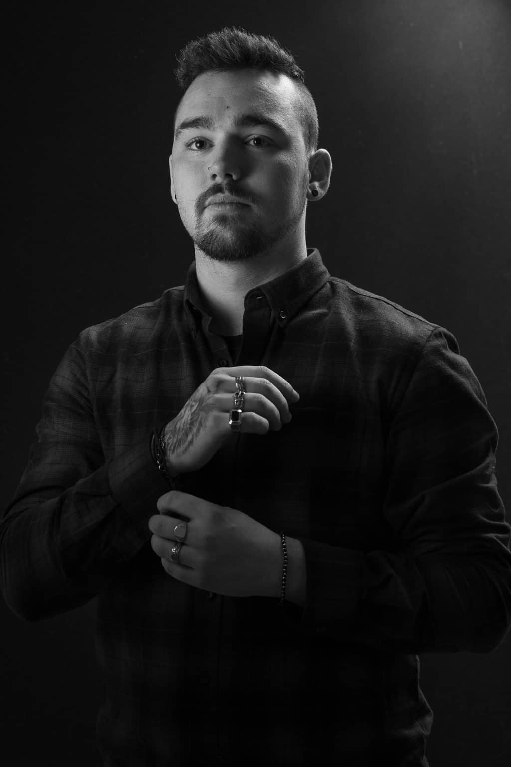 Black and white studio portrait of a man