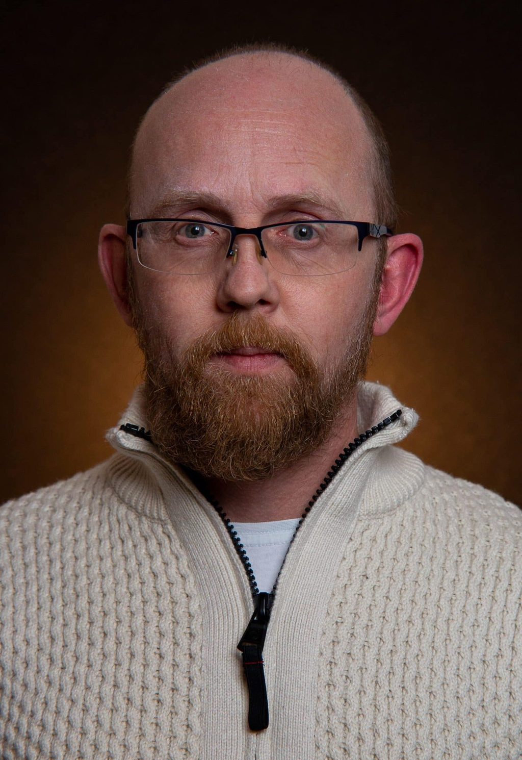 Studio portrait of a man in a knitted jumper