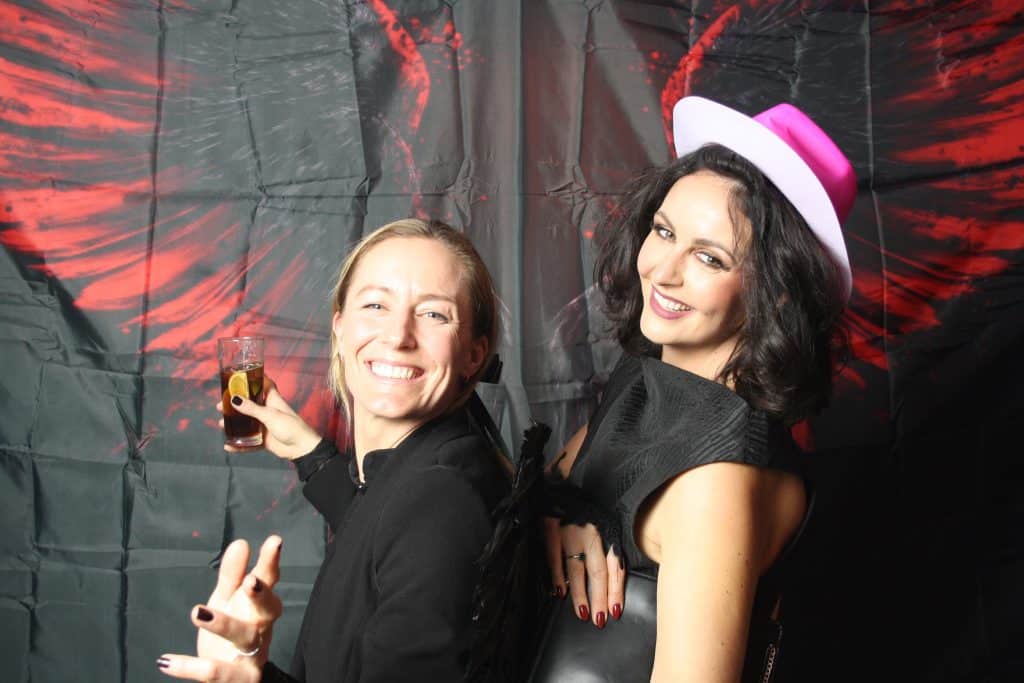 Party guests striking a pose in the open-air photo booth