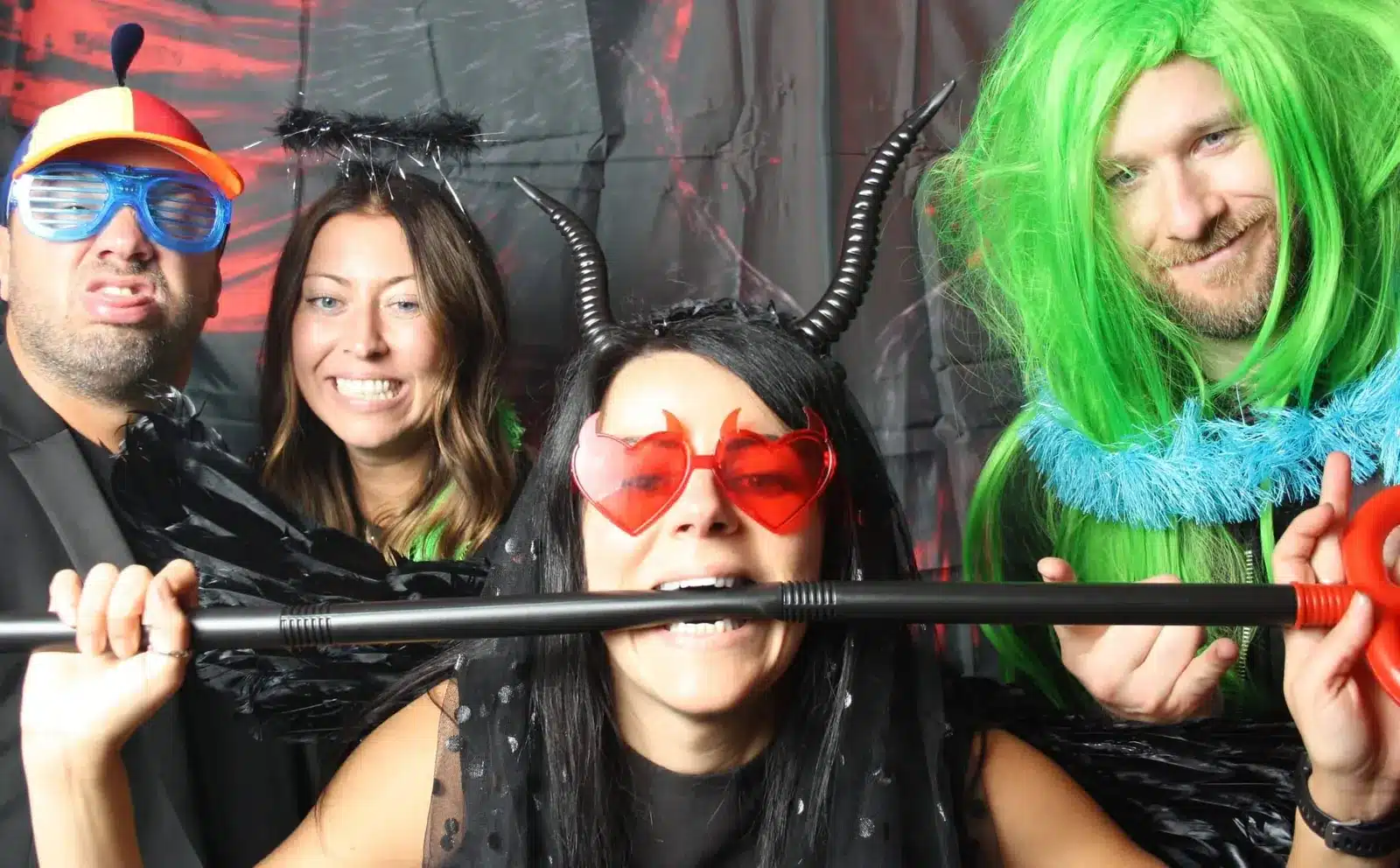 Guests in fancy dress props laughing in the Fun Casino Fun photo booth
