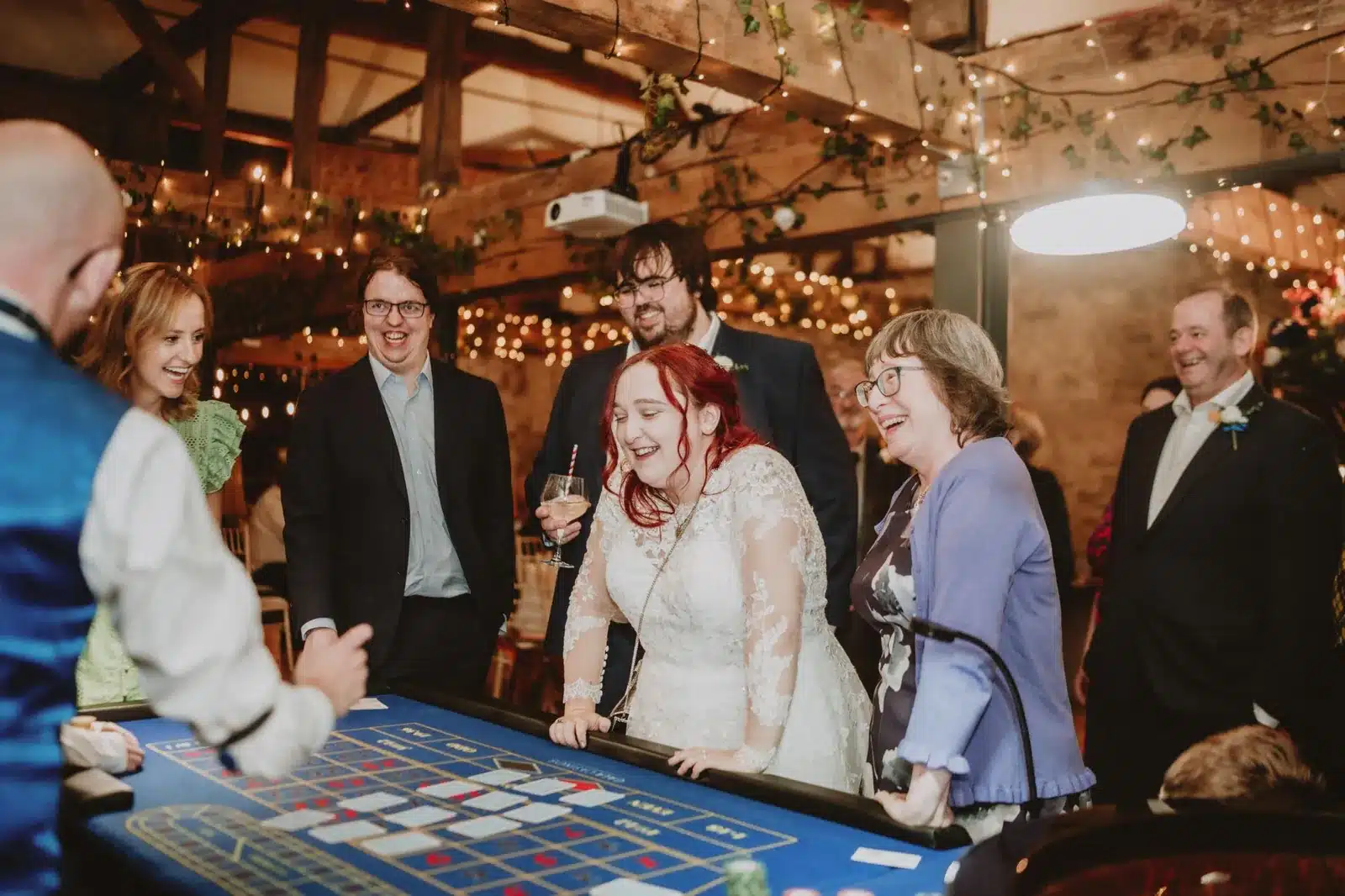 Bride laughing with wedding guests at a Fun Casino Fun roulette table